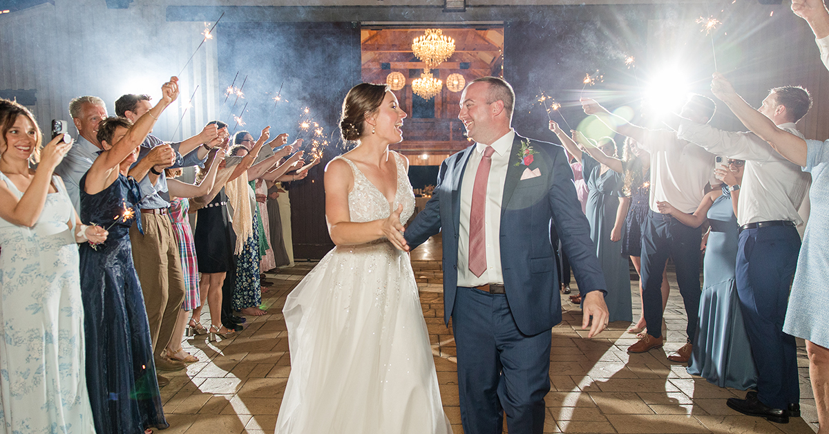 Bride & groom laugh at each other during their sparkler exit at their wedding near West Jefferson, NC